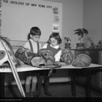 Children studying masks, Natural Science Center, 1962